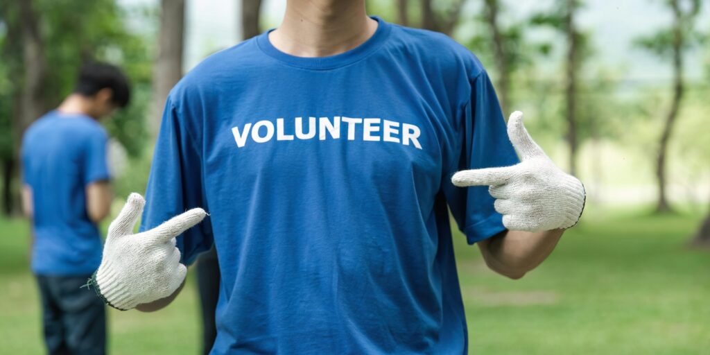 Close up young man volunteering wearing t-shirt with volunteer message